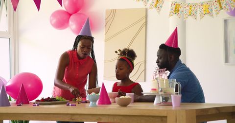 Family Celebrates Birthday at Home with Colorful Decorations