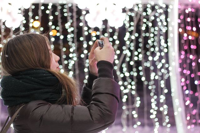 Woman Wearing Black Jacket Taking a Picture of Lights - Download Free Stock Photos Pikwizard.com