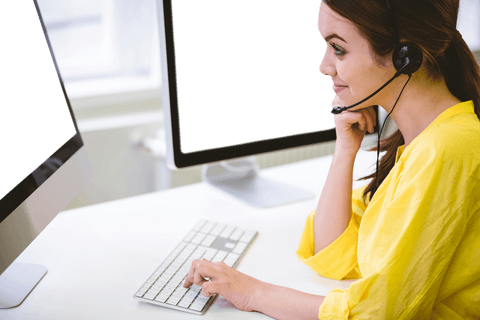 Woman Working on Desktop with Headset in Transparent Office Setting - Download Free Stock Videos Pikwizard.com