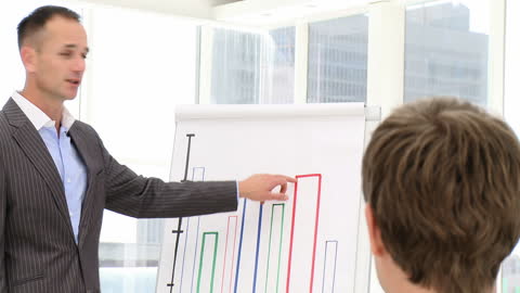 Businessman Delivering Presentation of Growth Chart in Office