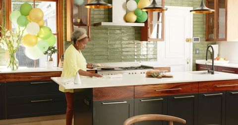 Senior Woman Decorating Kitchen for Festive Occasion