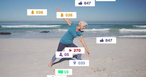 Senior Woman Practicing Yoga on Beach With Digital Interactions