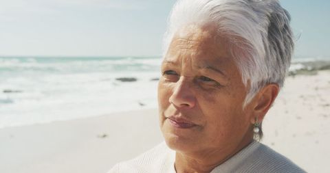 Thoughtful Senior Woman Enjoying Peaceful Beach Environment - Download Free Stock Images Pikwizard.com