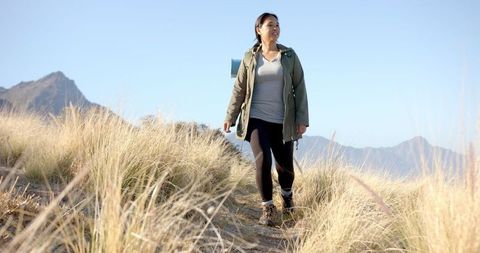 Woman Hiking Scenic Mountain Trail Enjoying Nature and Outdoor Adventure