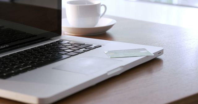 Credit Card on Laptop Next to Coffee Cup on Wooden Desk - Download Free Stock Images Pikwizard.com