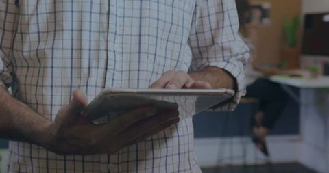 Business Professional Using Tablet in Open-Plan Office Environment