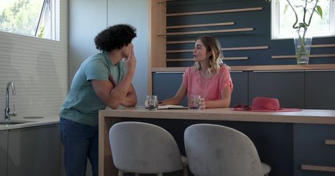 Couple collaborating in modern kitchen on home plans