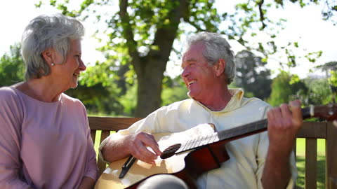 Elderly Couple Enjoying Music Together in Park