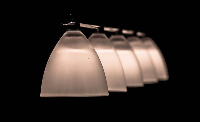 Modern pendant lights in a dark room, creating elegant lighting suitable for stylish home decor, interior design concepts, and mood lighting settings. Ideal for use in advertisements, creative projects, or articles about interior design and lighting.