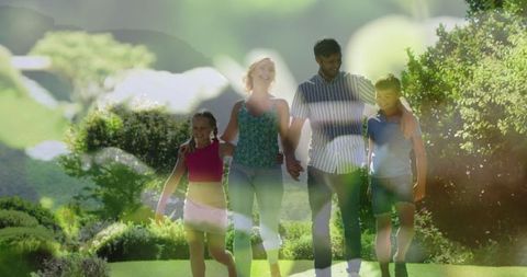 Happy Family Walking Together in Sunny Nature Setting