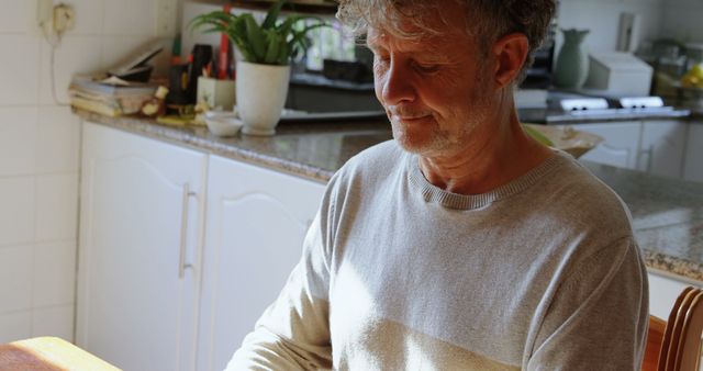 Middle-aged Man Enjoying Morning Sunshine in Kitchen - Download Free Stock Images Pikwizard.com