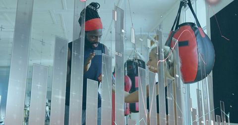 Coach expertly guides trainee through boxing gym workout