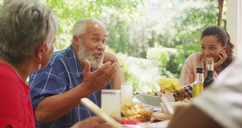 Family Enjoying Outdoor Summer Meal Together in Garden