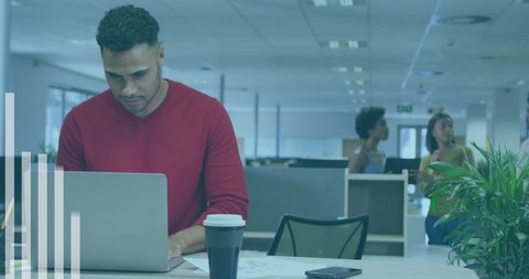 Focused professional analyzing data on laptop in modern office