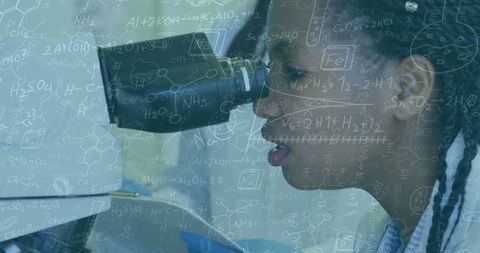 Young scientist enthralled with research through microscope