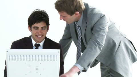 Business Colleagues Collaborating with Computer in Office