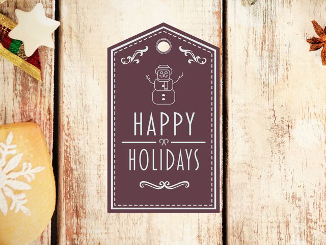 Celebrating holiday season, impactfully heartwarming holiday gift tag displaying a joyful greeting with a snowman graphic, neatly arranged on a rustic wooden background. Ideal for adding a festive touch to Christmas gifts, this tag is perfect for DIY wrapping projects, holiday themed presentations, and creating personalized and visually appealing gift packages.