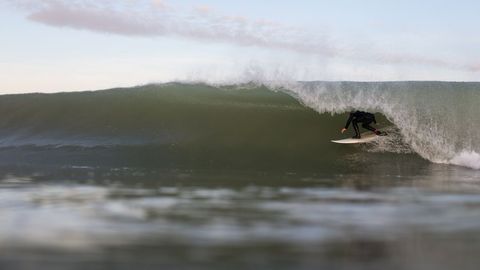 Surfer riding powerful ocean wave