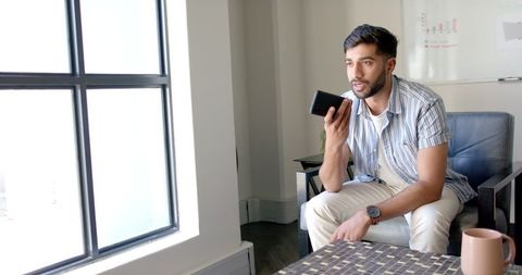 Business Professional Engaged in Phone Call in Modern Office