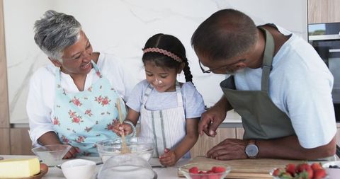 Grandparents Teaches Child Baking Joyfully in Modern Kitchen