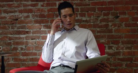 Business Professional Multitasking with Smartphone and Tablet