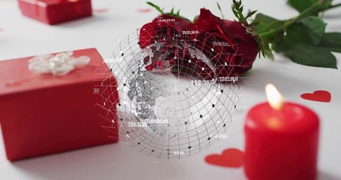 Global romance concept with red rose, gift box and candle featuring digital globe overlay
