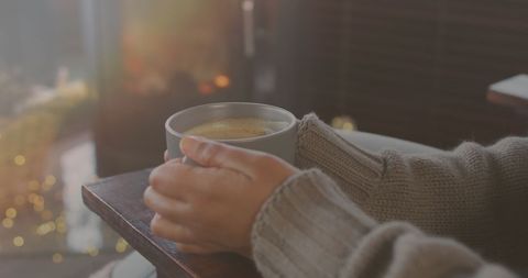 Cozy Comfort, Woman Holding Hot Beverage by Window