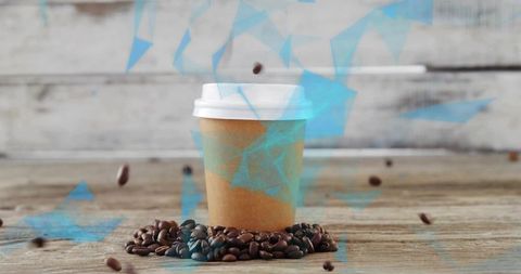 Sitting paper coffee cup with roasted beans and falling beans, blue geometric overlay