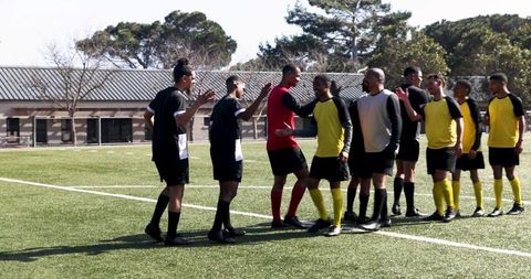 Diverse Young Soccer Teams Engaging in Sportsmanship at Field
