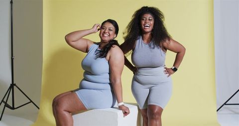 Confident Friends in Activewear Posing with Laughter