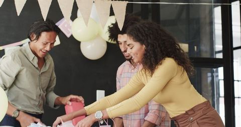 Colleagues preparing decorations for office party together