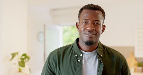 Mid adult man relaxing at home with natural light
