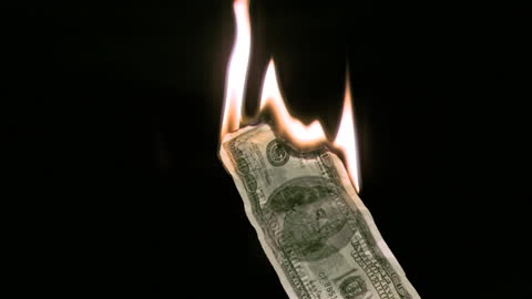 Burning Banknote in Dark Background Dramatic Effect