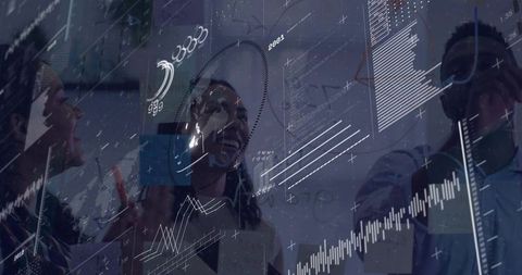 Collaborating team analyzing interactive data visualization on transparent glass board