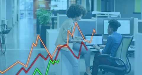 Diverse Colleagues Collaborating on Financial Data Analysis in Modern Office