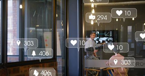 Business leader presenting data and social metrics to team in glass meeting room
