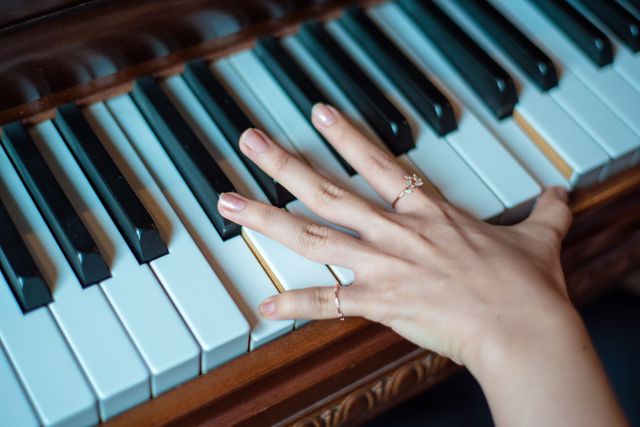 Close-Up of Hand Playing Piano with Rings on Fingers - Download Free Stock Photos Pikwizard.com