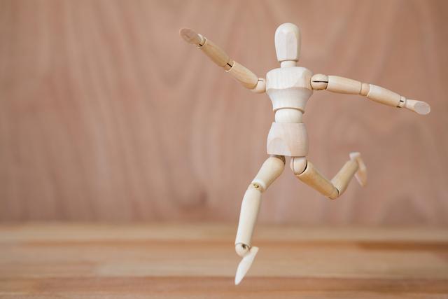 Conceptual image of figurine jogging on a wooden floor