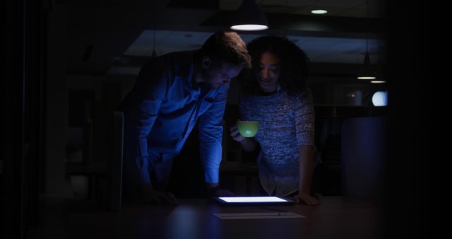 Two Colleagues Working Late Night Project in Dimly Lit Office - Download Free Stock Images Pikwizard.com