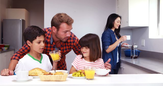 Happy Family Enjoying Breakfast Together in Kitchen - Download Free Stock Images Pikwizard.com