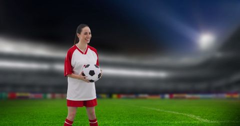 Female Soccer Player Holding Ball in Stadium at Night - Download Free Stock Images Pikwizard.com