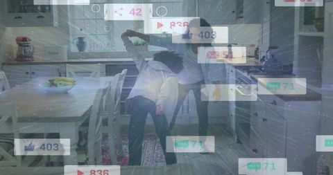 Mother dancing with child in cozy farmhouse kitchen, social media notification overlay