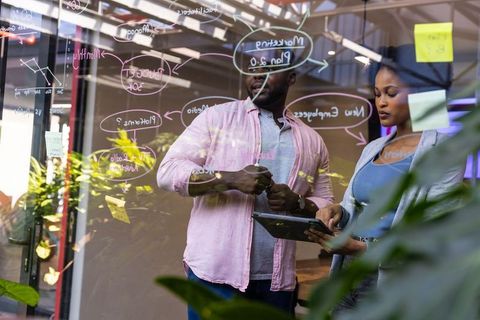 Coworkers Innovation Collaboration at Office Glass Wall