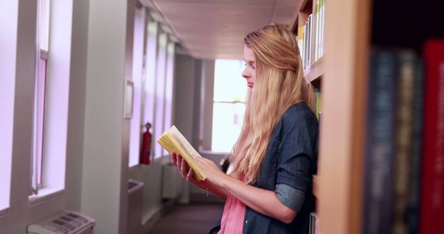 Young Woman Reading Book in Library - Download Free Stock Images Pikwizard.com