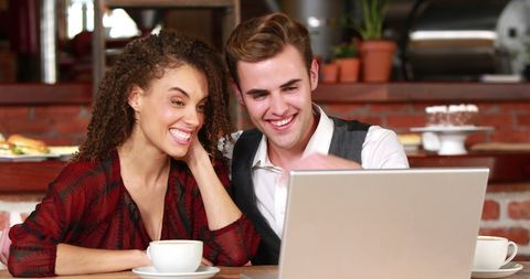 Happy Young Adults Collaborating on Laptop in Café - Download Free Stock Images Pikwizard.com