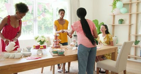 Friends Preparing Tea Party Celebration with Desserts