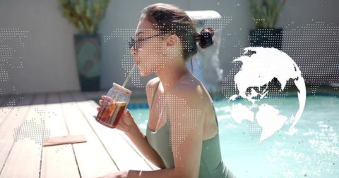 Woman sipping iced tea from mason jar by pool on sunny deck with globe overlay
