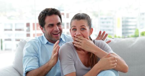 Couple Watching Exciting Scene on Television in Living Room - Download Free Stock Images Pikwizard.com