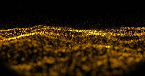Abstract golden particle wave on black background
