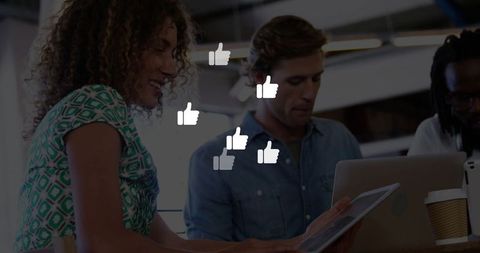 Colleagues Reviewing Tablet in Modern Office with Like Icons